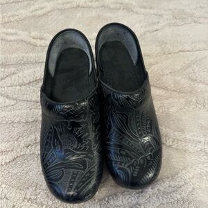Dansko Black Floral Embossed Clogs